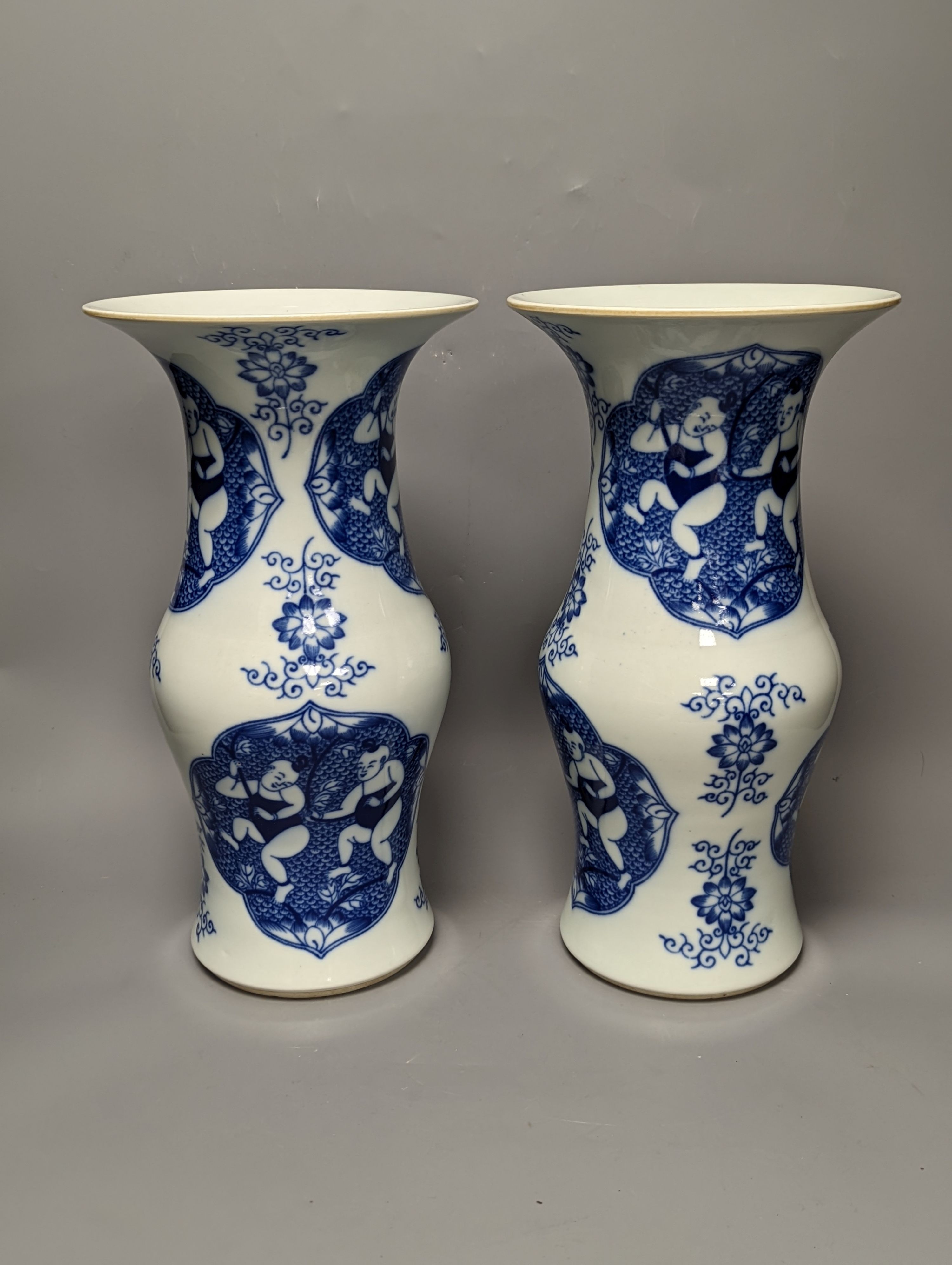 A pair of Chinese blue and white vases on stands and 6 further wood stands. Vases 35cm